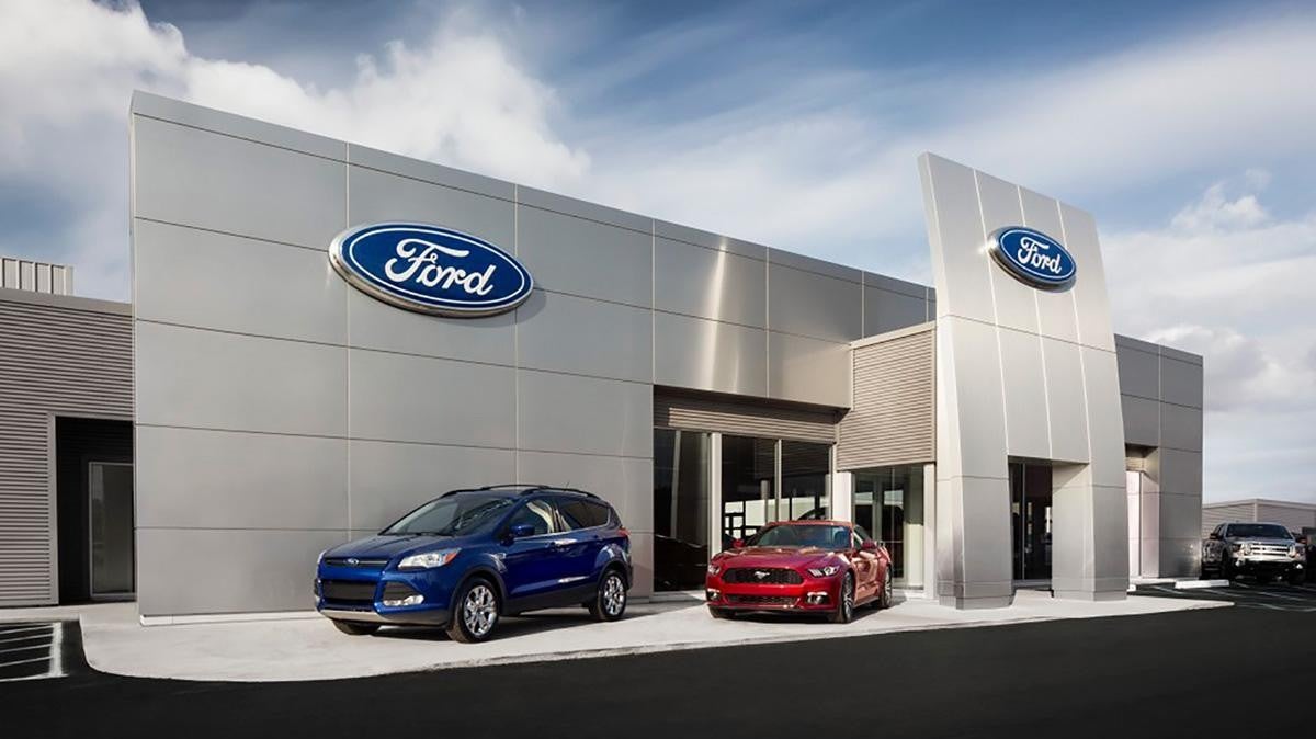 Ford dealership building with cars parked in front